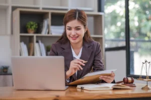 female lawyer working in office with contract and law books